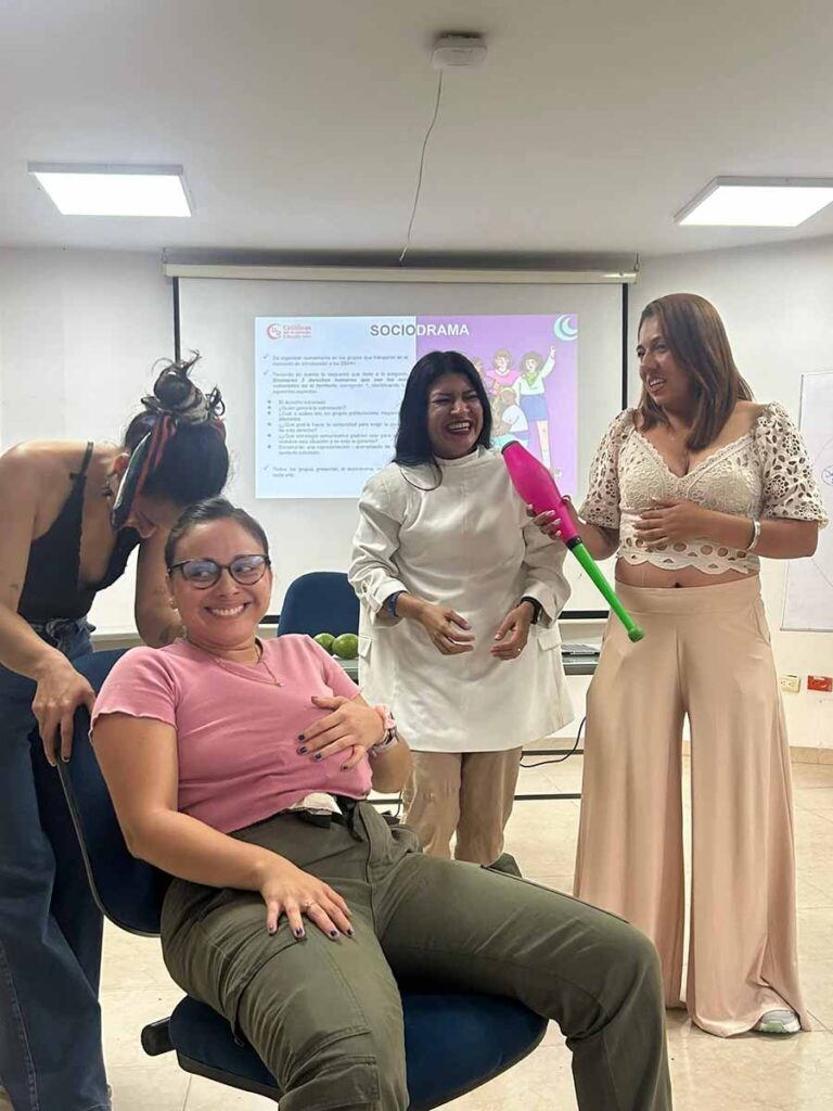Mujeres que ríen mientras realizan una actuación lúdica.